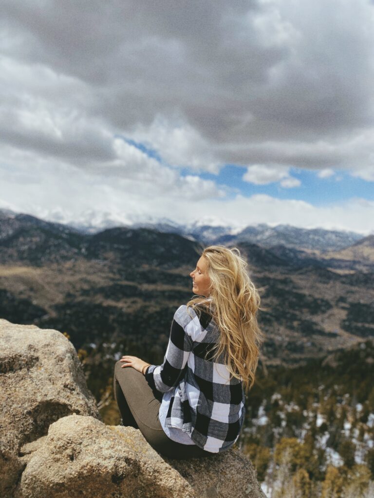 girl sitting on a mountain top