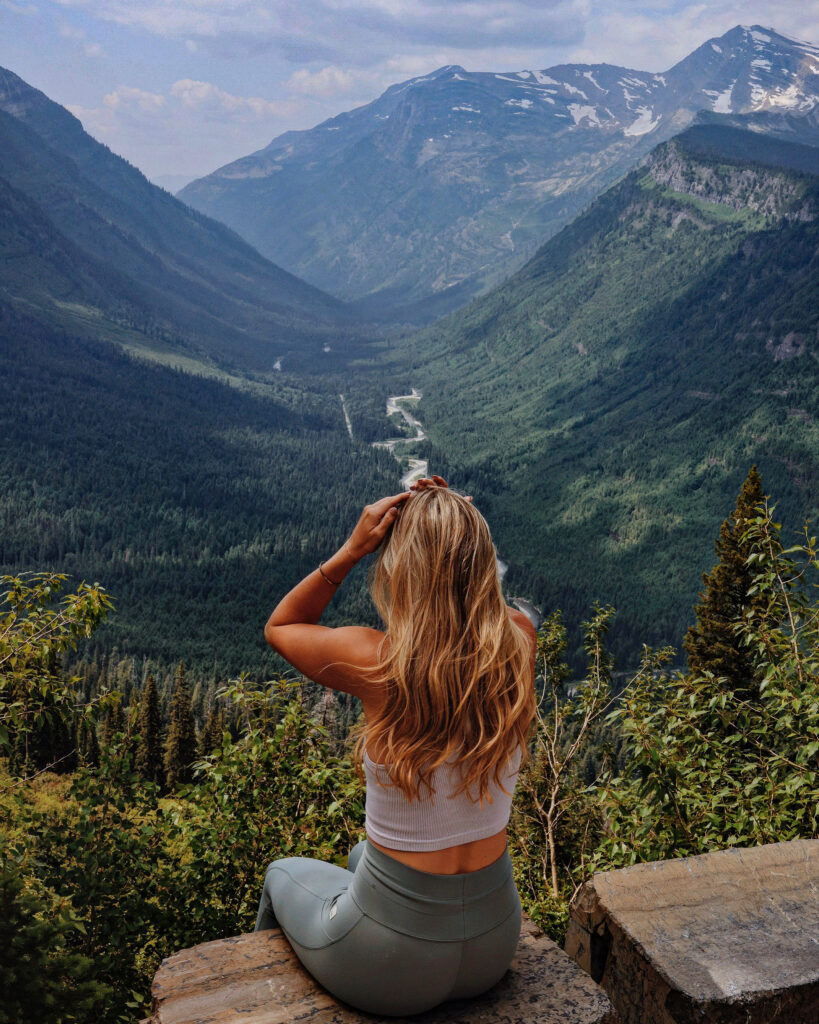 girl overlooking going to the sun road