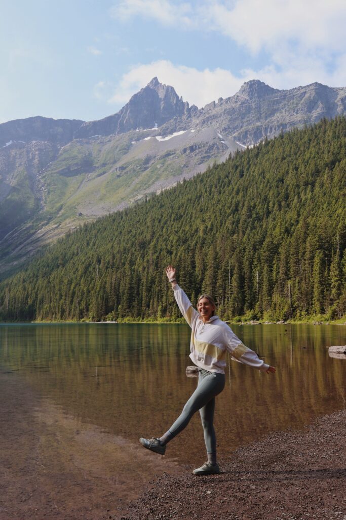 girl standing in front of glacial lake