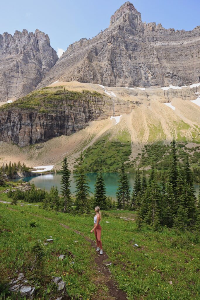 girl hiking with gorgeous mountain scenery and alpine lake