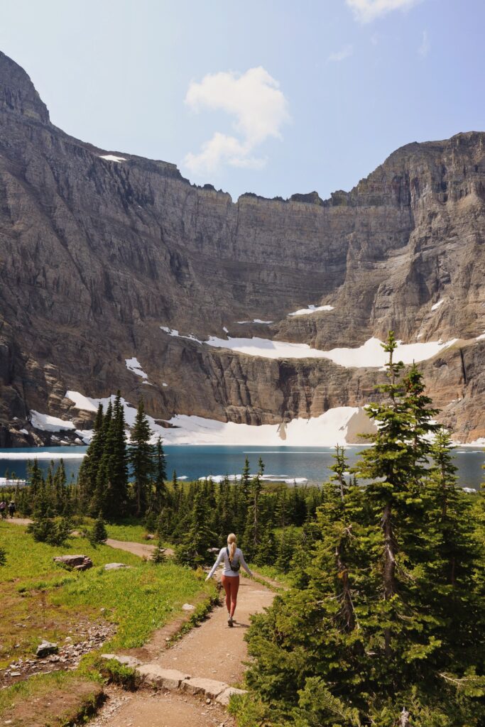 girl hiking in front of blue lake